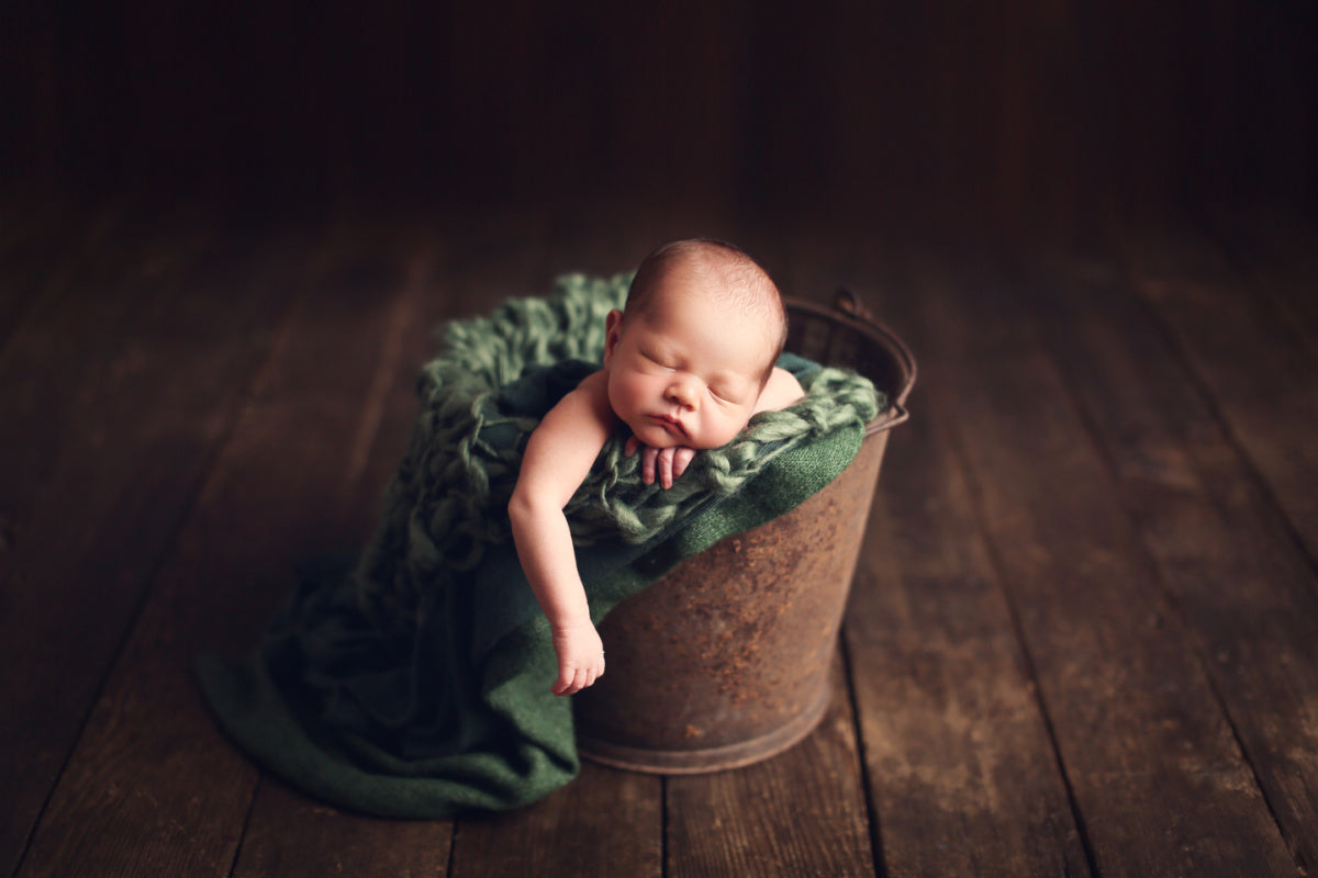 baby boy in bucket with textured, knit, chunky blanket photography props by custom photo props