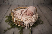 newborn girl with peach fuzzy sleepy hat, matching chunky wool layer and bowl