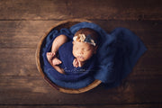 newborn baby in blue swaddling wrap inside bowl