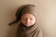 brown tones newborn baby swaddling wrap and matching baby hat in photos
