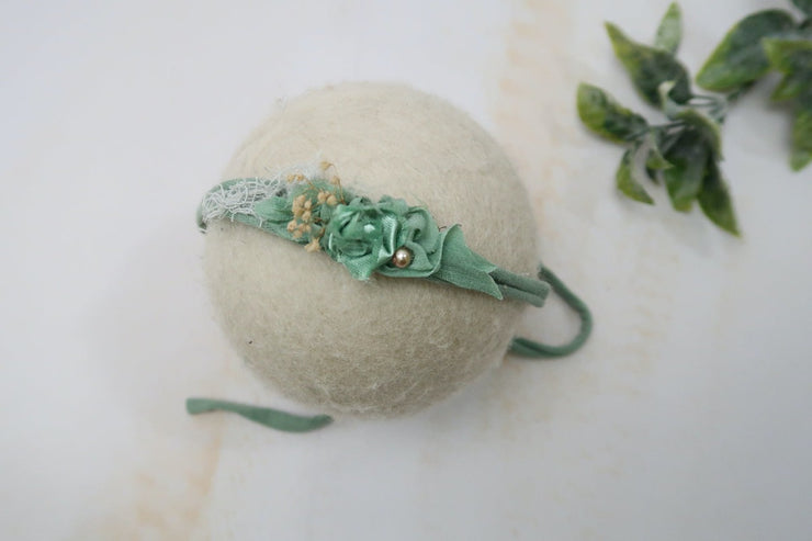 green newborn baby girl headband with pearls and adjustable band