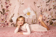 pink flower backdrop with young girl