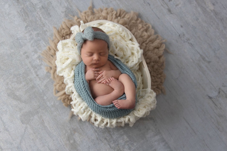 newborn girl in blue mohair bow headband in egg pose by custom photo props