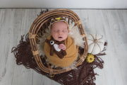 dark brown accent rug under baby newborn photo props