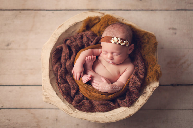 bronze copper newborn baby girl in bowl with other matching photo props