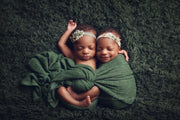 dark green curly faux fur photography props with twin girls in swaddling wrap by custom photo props