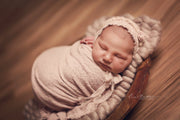 Baby boy swaddled in white baby wrap with relaxed swaddler sack photography prop