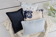assorted newborn baby posing pillows, fuzzy gray, embroidered fabric, blue suede, flower