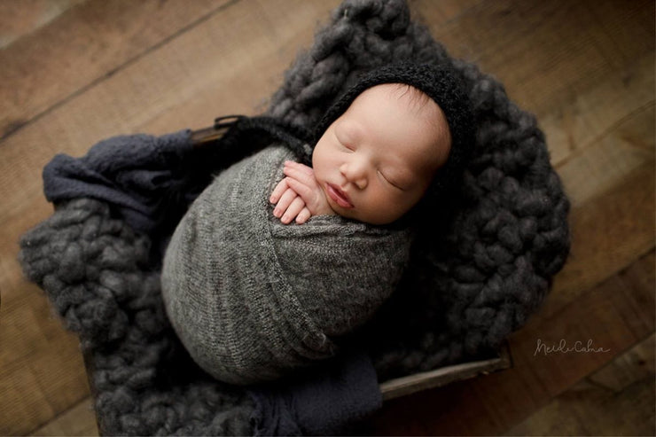 newborn baby boy swaddled in dark gray fuzzy sweater swaddle wrap. American made baby wrap by Custom Photo Props.