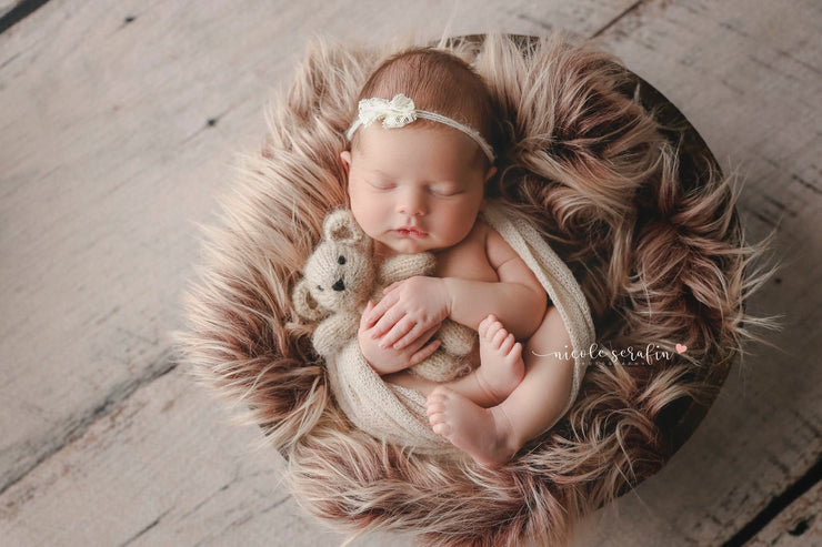 long, two tone straight, newborn faux fur photo prop with baby girl holding small bear