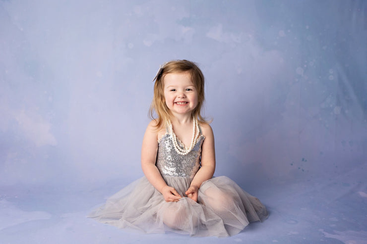 little girl with blue photo backdrop by custom photo props