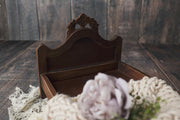 dark stained newborn baby bed with carved flower on headboard by custom photo props