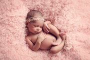 pink curly, faux flokati newborn fur photography prop with baby girl and lace headband