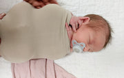 newborn baby in swaddling sack so baby stops fussing