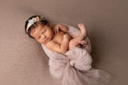 newborn girl in large fabric bow for newborn pictures