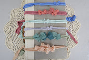 colorful set of newborn baby bow headbands for new moms or newborn photographers