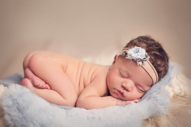 newborn girl with handmade flower headband and adjustable band with blue fur props by custom photo props