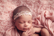 close up photo of newborn indian girl with pink fur