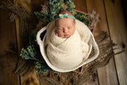 ivory newborn baby girl swaddled in fuzzy, mink, newborn baby wrap by custom photo props