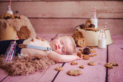 toddler kid with bookies sleeping during photo shoot