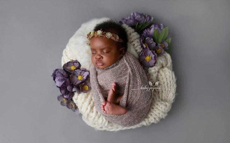 newborn baby girl swaddled in fuzzy pink stretch wrap photo prop by custom photo props
