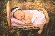 little asian newborn girl with halo on bamboo or can newborn bed photography prop