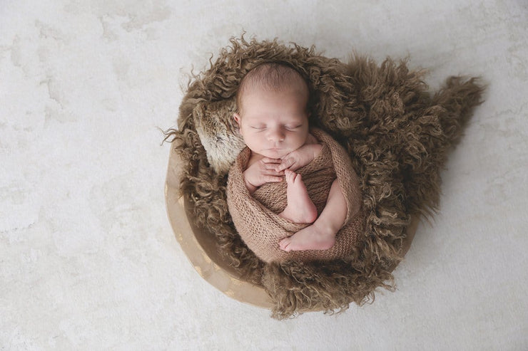 medium brown faux fur flokati newborn photography prop with baby boy in brown bowl