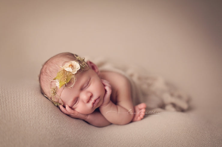 newborn baby girl posed with hemp and flower halo