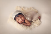 newborn baby girl with ivory faux flokati fur and lace layering blanket photo prop