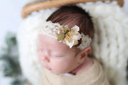close up image of newborn girl headband with cream and beige lace flower headband