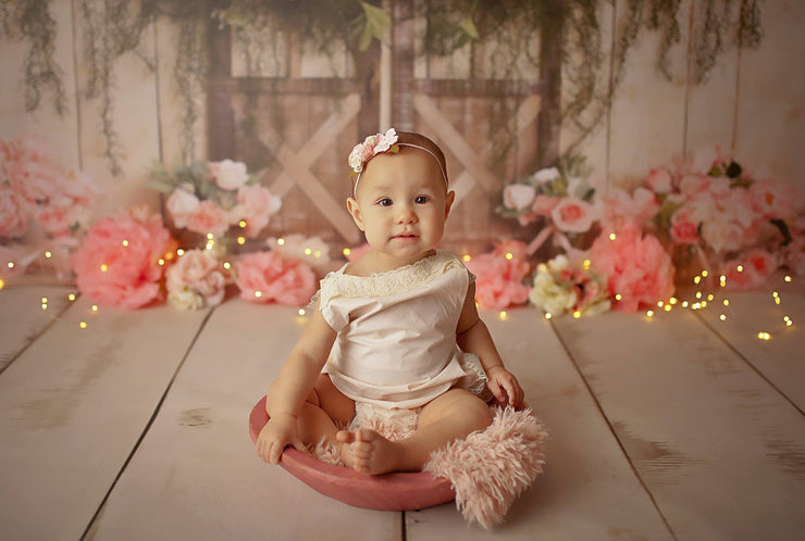 little girl sitting in round wood bowl photography prop with small fur