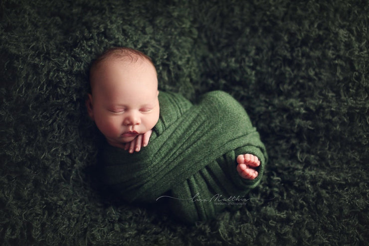 dark green curly faux fur photography props with baby boy in swaddling wrap by custom photo props