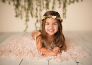 little girl laying on soft peach faux fur fabric during photos