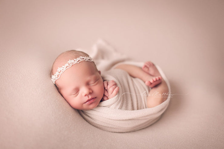 super light pink swaddling wrap on girl with posing cloth. newborn posing custom photo props